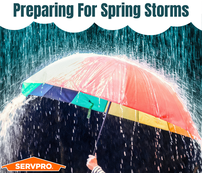 Multi-color umbrella blocking heavy rain with the title, "Preparing For Spring Storms" up top and a SERVPRO logo beneath